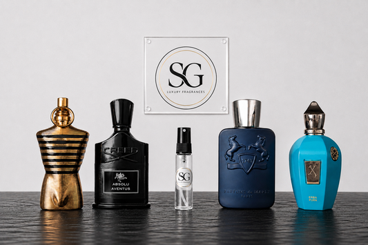 Five different perfume bottles on a wooden surface with a branded sign in the background.