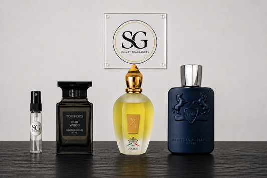 Collection of perfume bottles on a wooden surface with a branded plaque in the background.