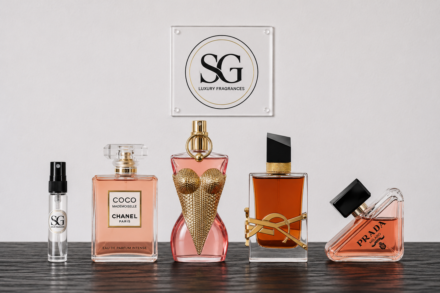 Collection of perfume bottles on a wooden surface with 'SG Luxury Fragrances' logo in the background.