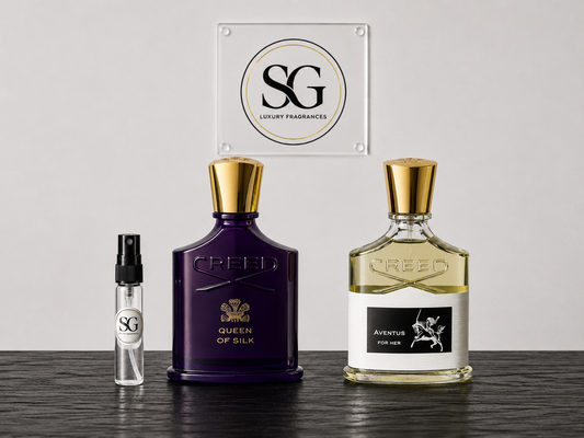 Two Creed perfume bottles on a wooden surface with a branded sign in the background.