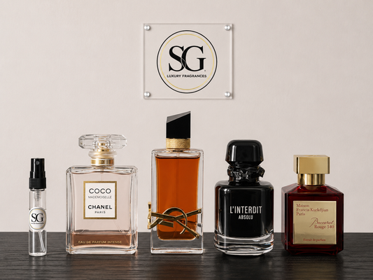 Collection of luxury perfumes on a wooden surface with a branded plaque in the background.