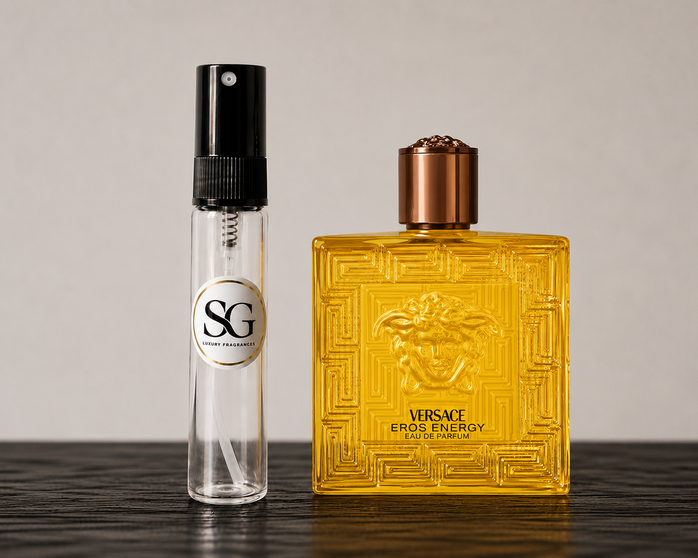 Two perfume bottles, one clear with black cap and one yellow with bronze cap, on a dark surface.