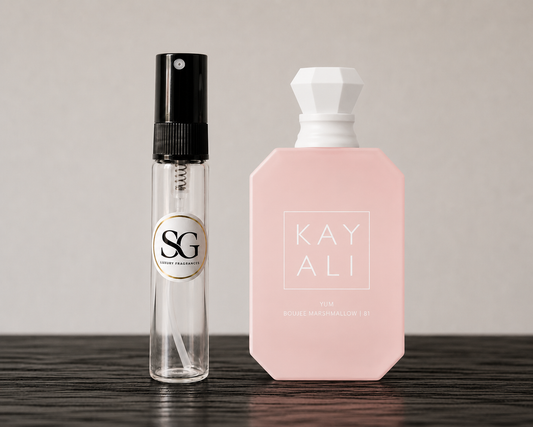 Clear spray bottle with black top and pink bottle with white top on a wooden surface.