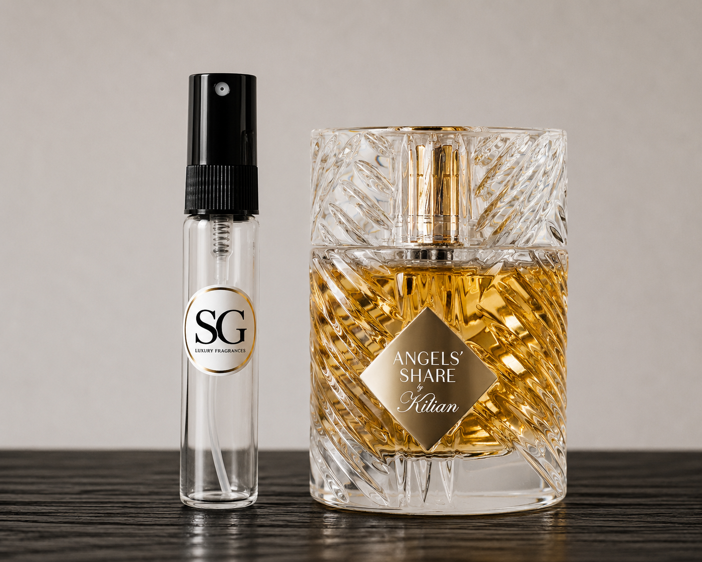 Two perfume bottles, one large and one small, on a wooden surface with a neutral background.