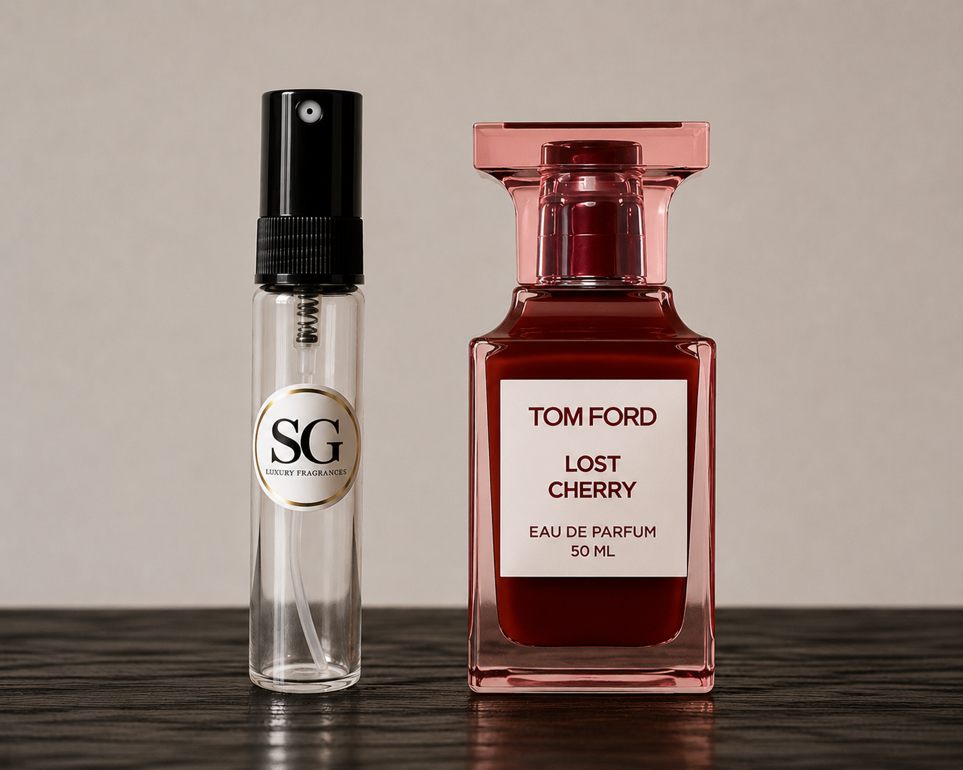 A Tom Ford Lost Cherry Eau de Parfum 50ml bottle next to a clear glass sample spray vial with a black pump and a circular SG (Scent Gallery) logo label, set on a dark wooden surface against a neutral beige background.