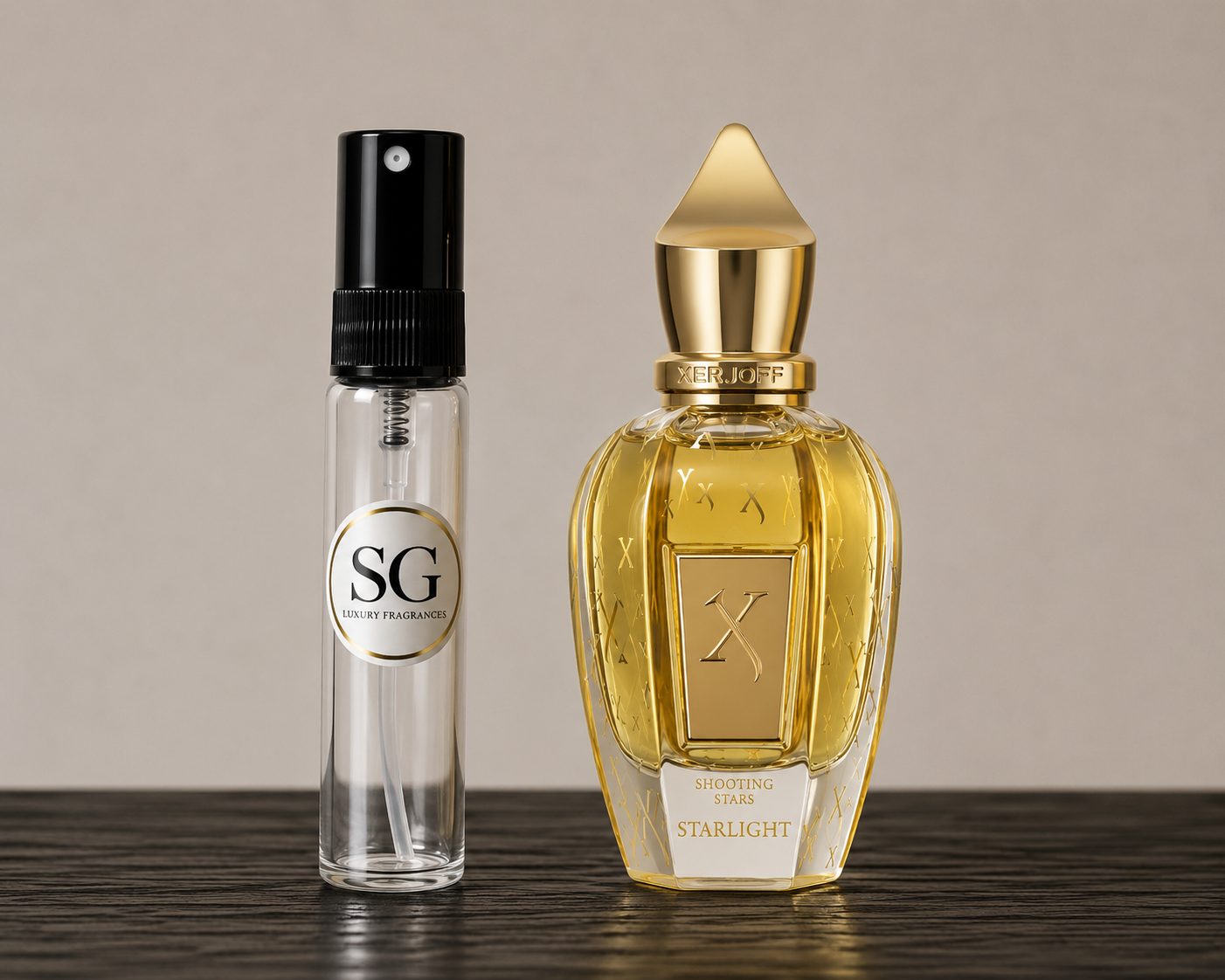 A clear glass perfume atomizer spray bottle with a black spray top and a circular white label reading SG, placed beside a larger faceted gold perfume bottle labeled X Starlight, both on a dark wooden surface against a warm beige background.